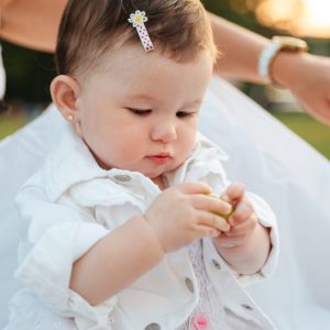 cute-little-girl-sitting-playing-outdoors